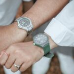 A couple holding hands, showcasing stylish wrist watches.