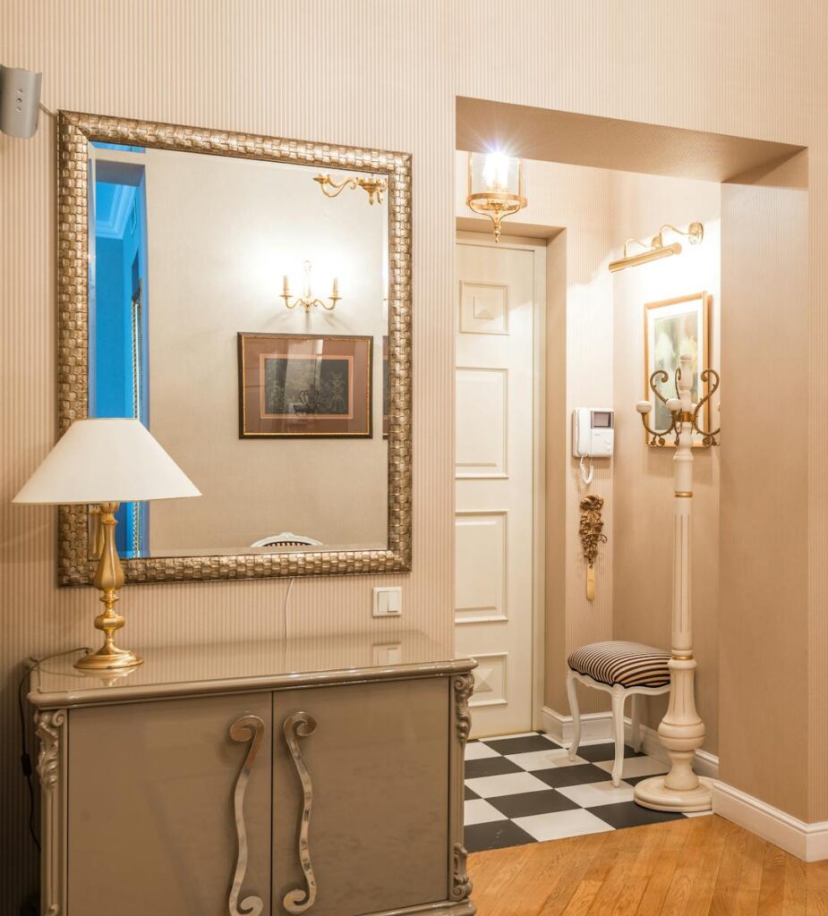 Chic vintage hallway with mirror, lamp, and checkered floor for homely ambiance.
